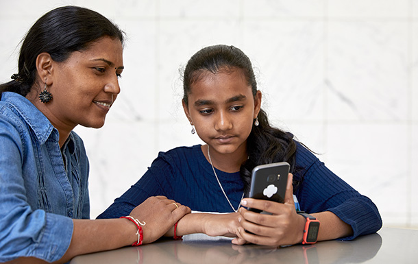 Mother and daughter looking at a cell phone